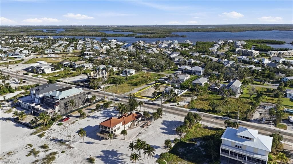 Aerial overview of property's location with nearby suburban area and a large body of water - Virtually Edited Image