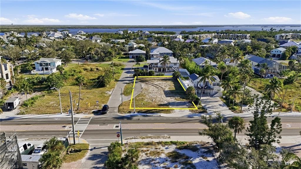 Aerial perspective of suburban area featuring property parcel outlined - Virtually Edited Image