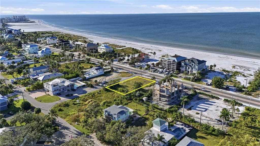 Aerial perspective of suburban area with property boundaries highlighted and expansive coastline - Virtually Edited Image