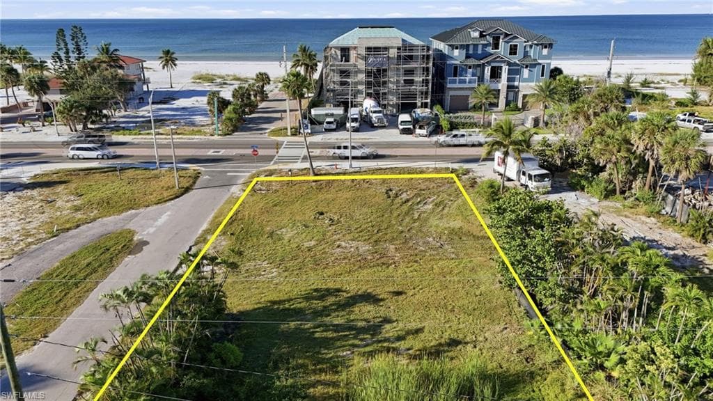 Aerial view of property's location with property boundaries highlighted and extended coastline - Virtually Edited Image