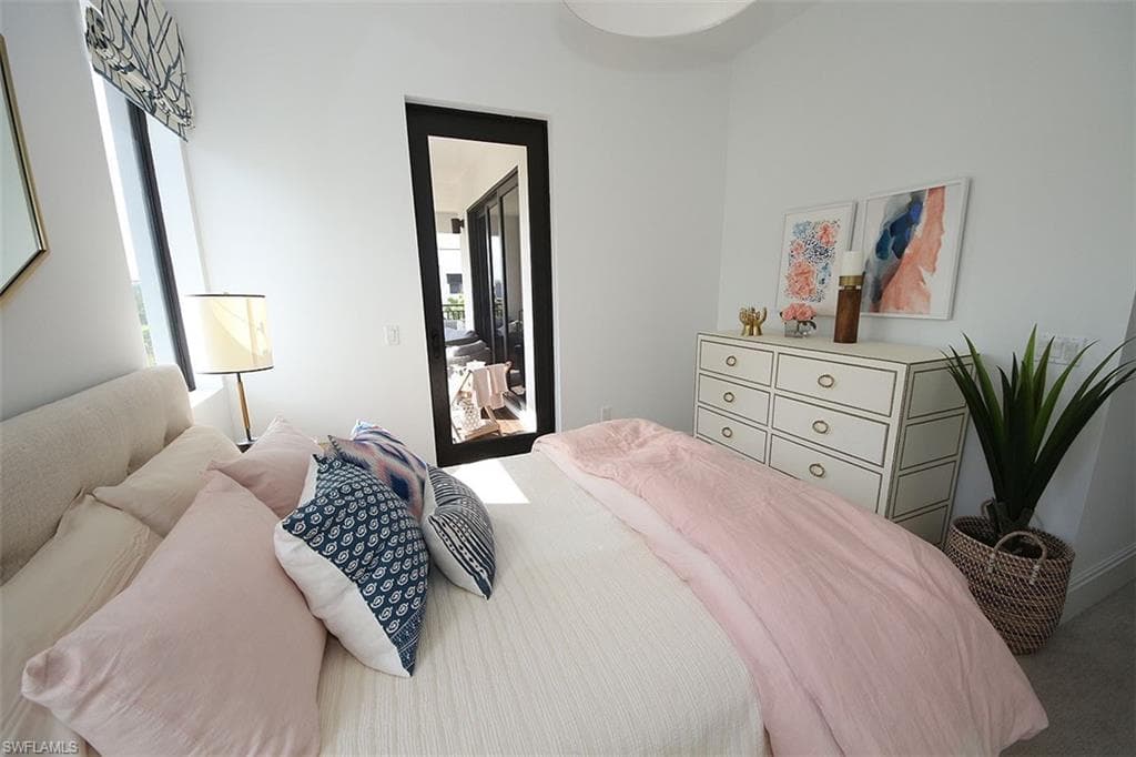 Bedroom featuring multiple windows and access to outside