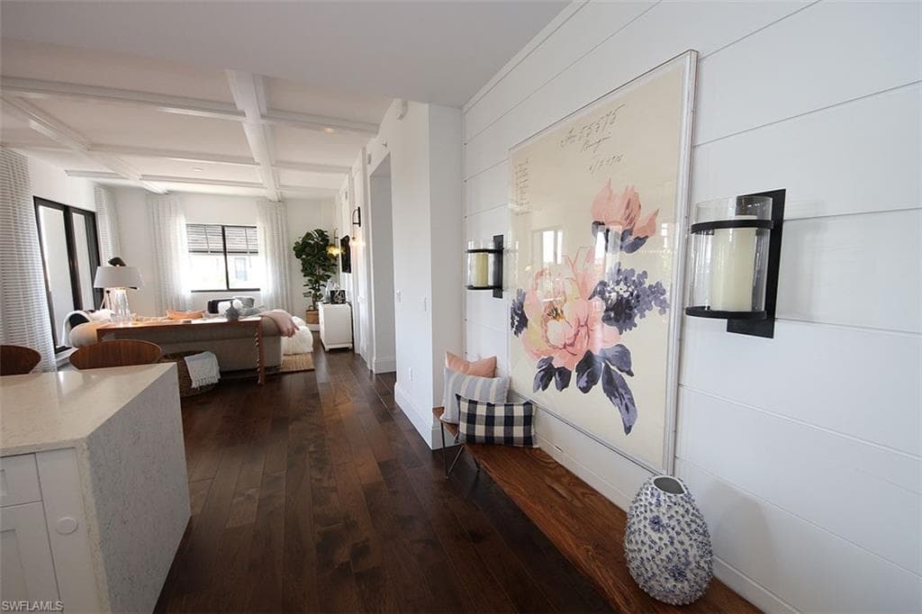 Hall with coffered ceiling, dark wood-style floors, and beamed ceiling