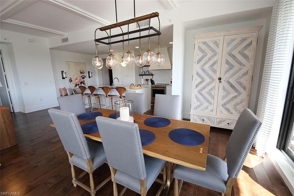 Dining space featuring dark wood-style floors and baseboards