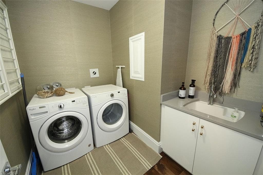 Laundry area featuring washer and clothes dryer and cabinet space