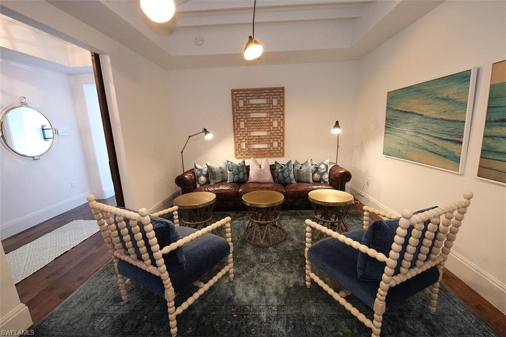Sitting room featuring wood finished floors and a raised ceiling