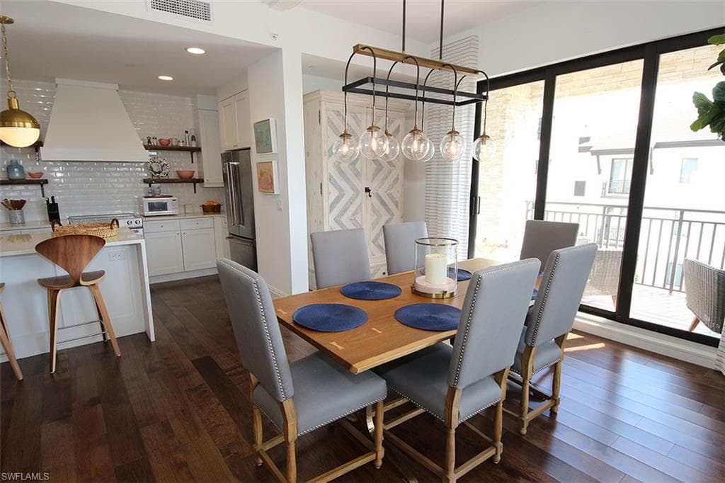 Dining room with dark wood-type flooring
