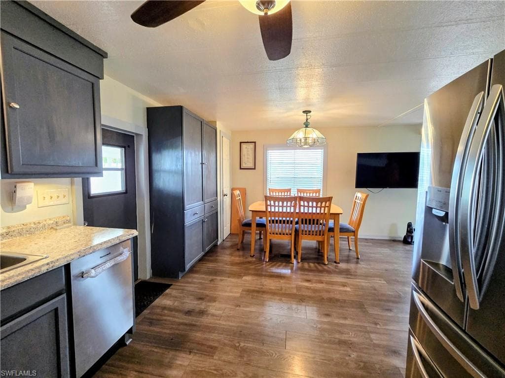 Ceiling fans, 6-panel doors, and lustrous wood laminate flooring & tile throughout.