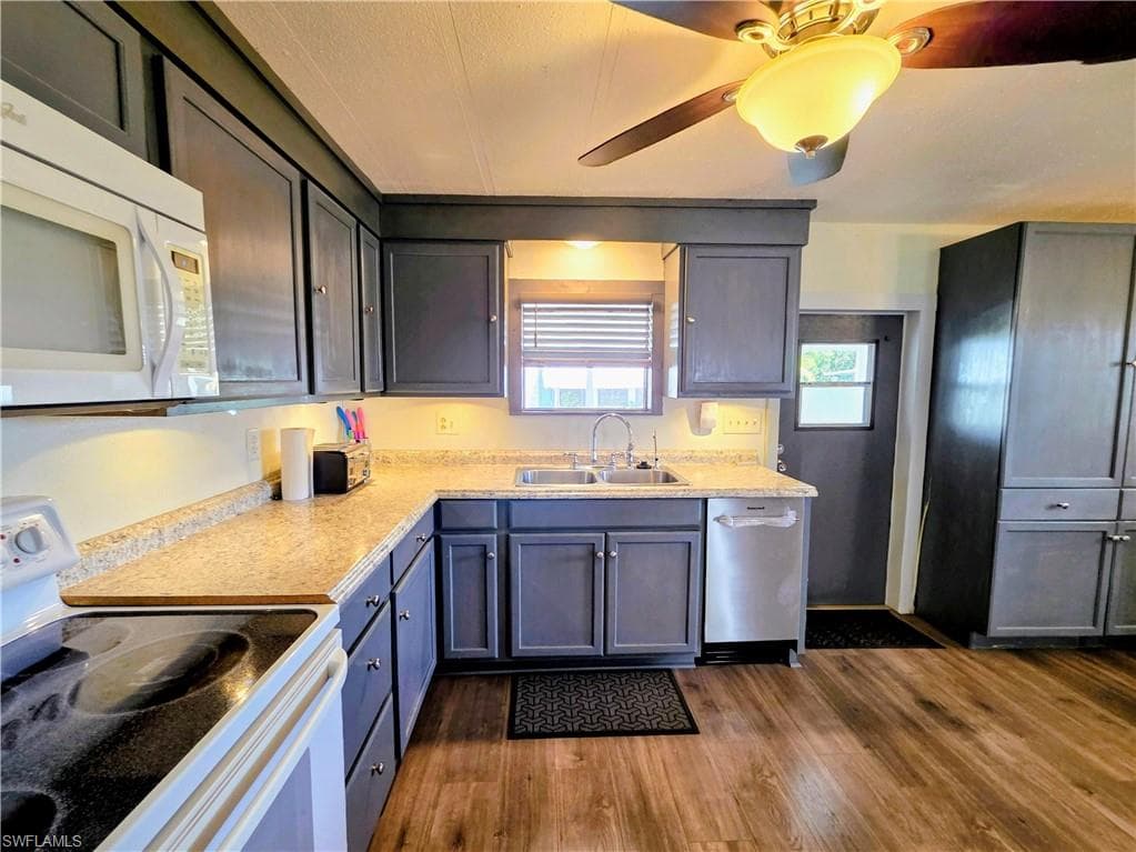 Your bright & airy updated Kitchen features raised-panel cabinets, newer dishwasher & disposal, glass-top stove, and lustrous wood laminate floor!