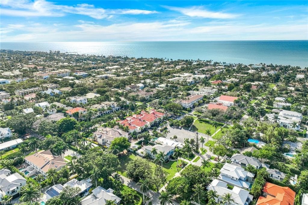 Aerial view of property's location featuring a large body of water and nearby suburban area