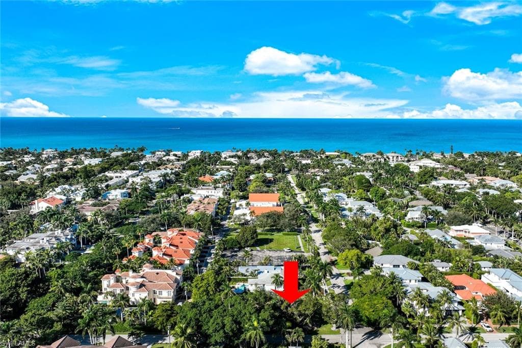 Aerial perspective of suburban area with a nearby body of water