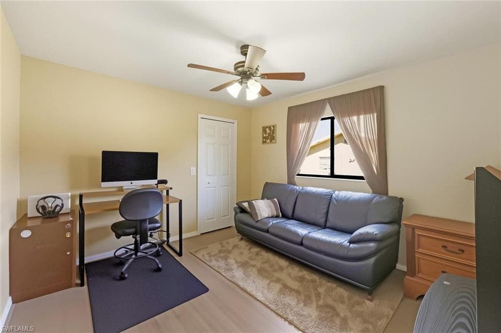 Office area featuring ceiling fan and wood finished floors