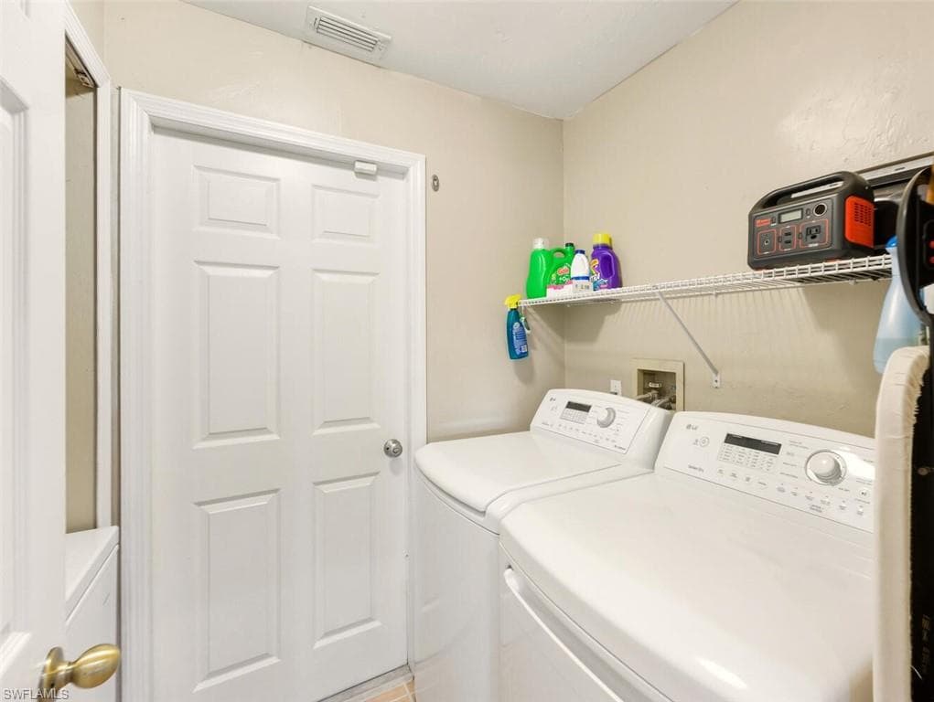 Laundry room with washer and clothes dryer