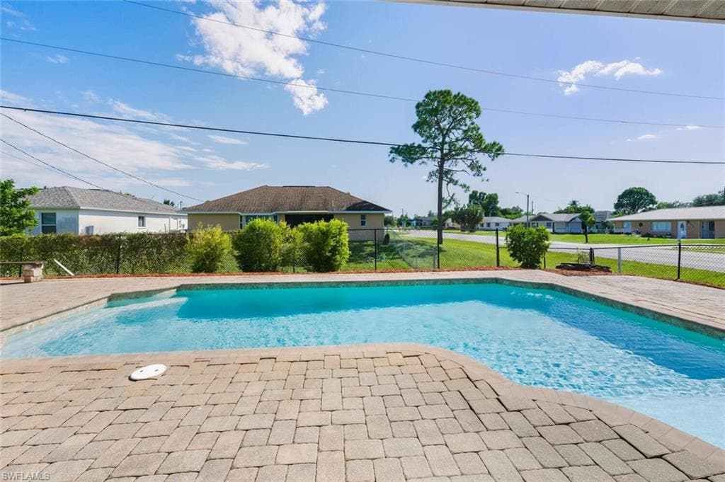 View of swimming pool with a patio area and a residential view