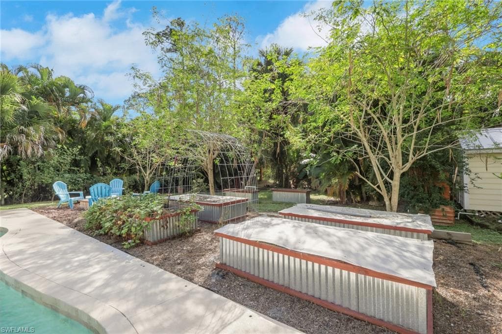 Backyard space with raised garden beds to plant your own fruits and vegetables, firepit, tons of fruit trees throughout the yard, shed, workshop, chicken coop, guest house, and so much more