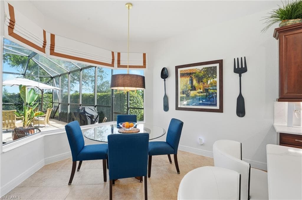 Dining area featuring a sunroom and light tile patterned floors