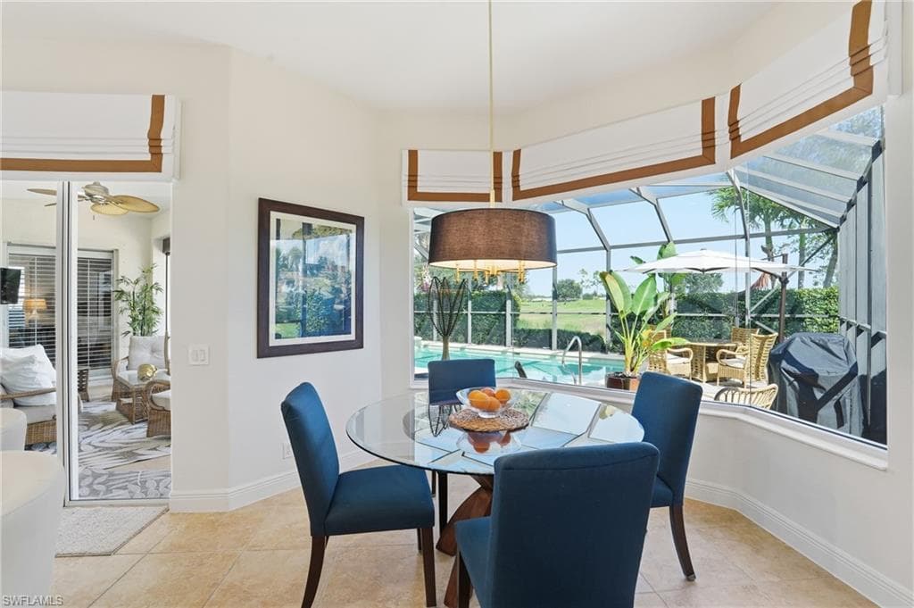 Dining area featuring a sunroom and light tile patterned flooring