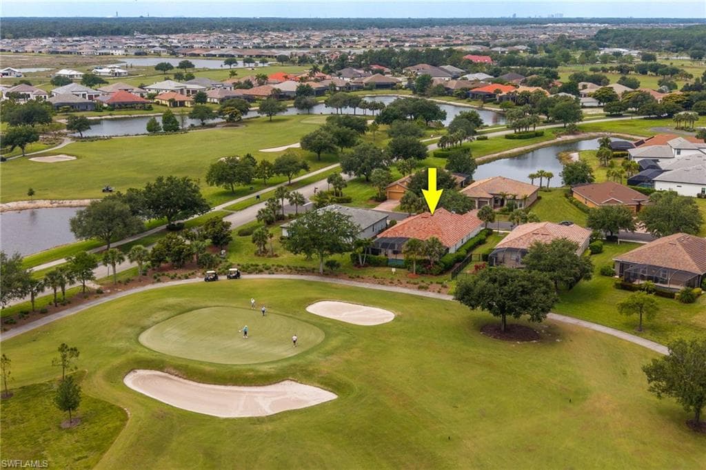 Aerial view of golf course and back of home.