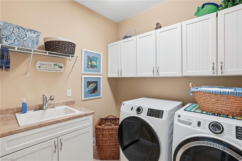 Laundry room with separate washer and dryer and cabinet space