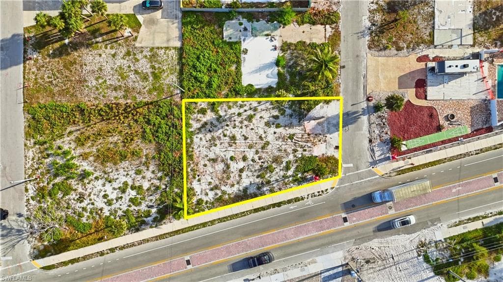 Aerial view of property and surrounding area featuring property boundaries highlighted - Virtually Edited Image