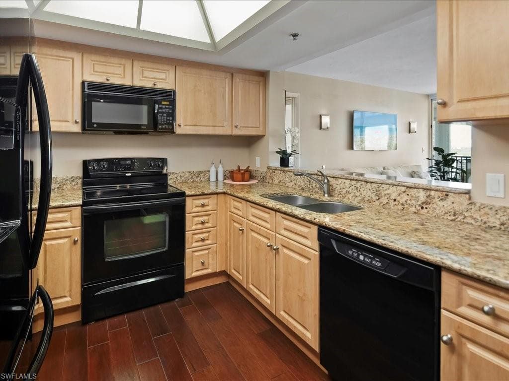 Granite countertops, light wood cabinets, stainless sink