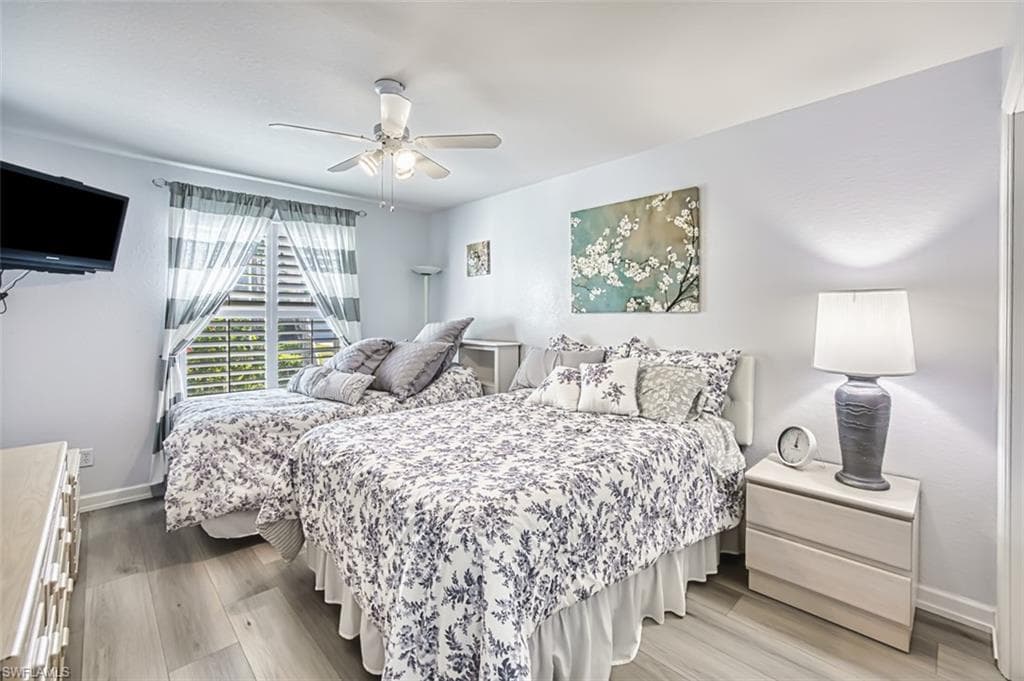 Bedroom featuring ceiling fan and wood finished floors