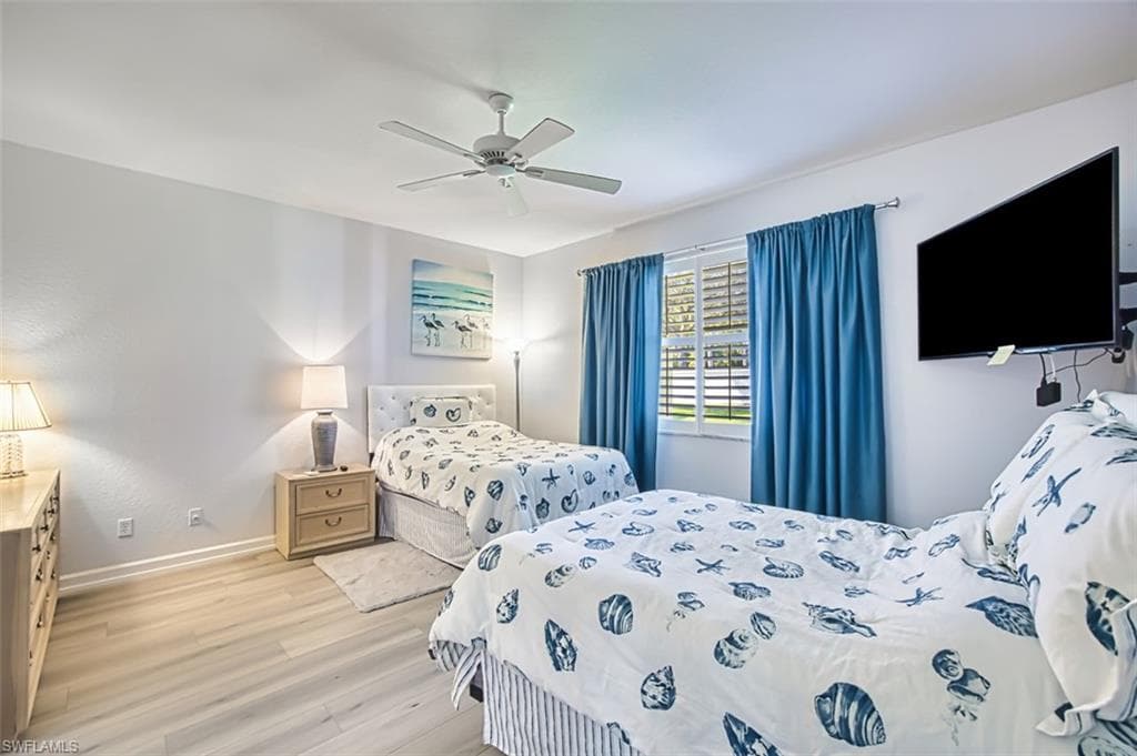Bedroom with light wood-style floors and ceiling fan