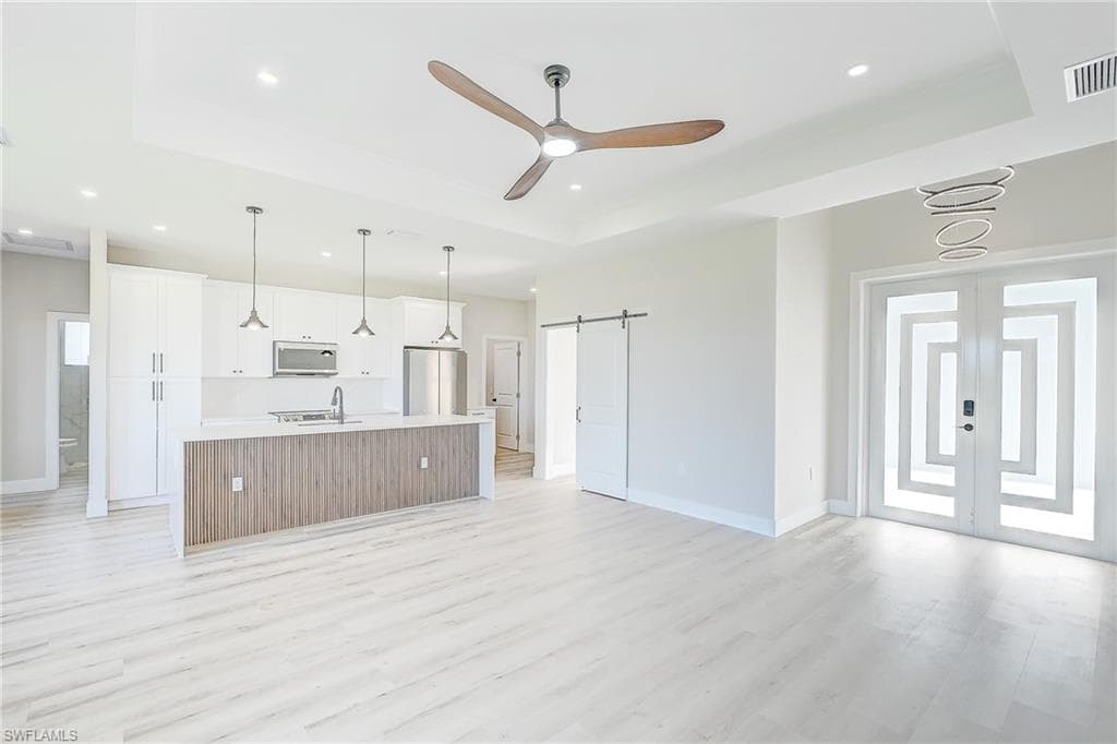 Dining space with light wood-style floors and a chandelier