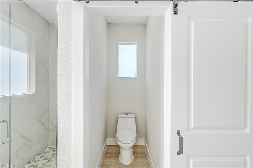 Empty room featuring a tray ceiling, light wood finished floors, a ceiling fan, crown molding, and recessed lighting