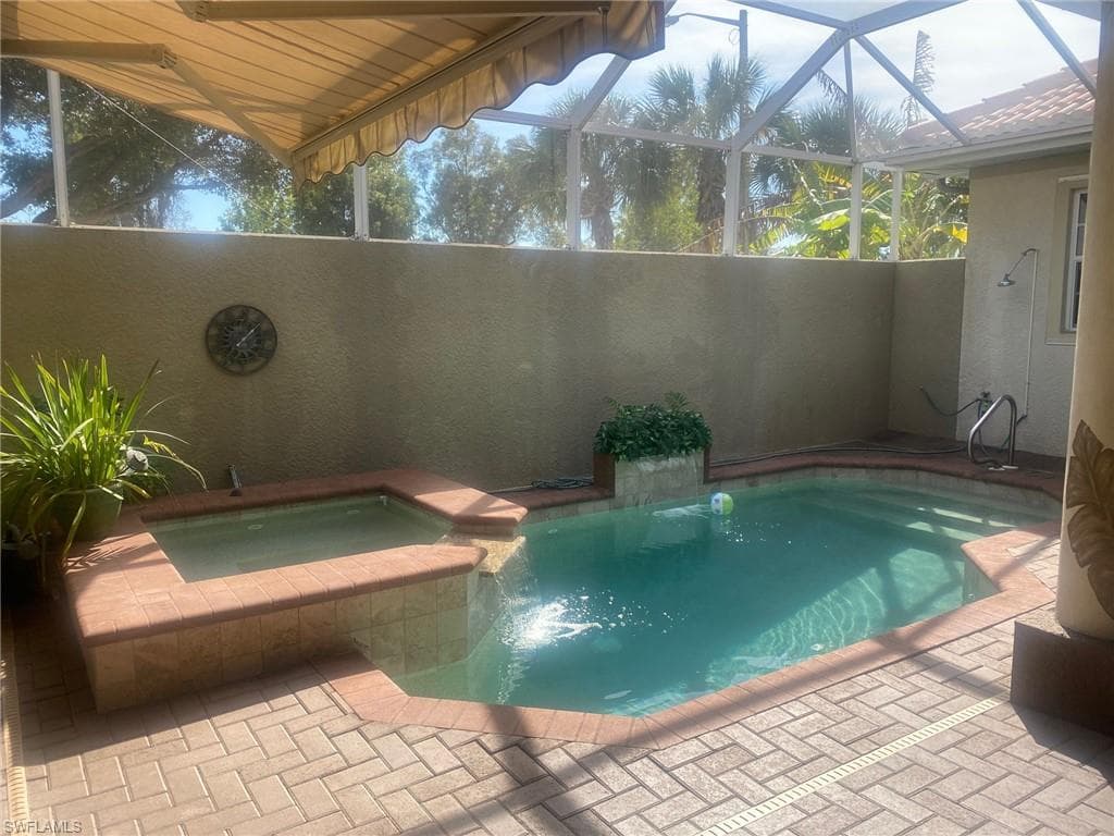 Pool area with water features and privacy wall