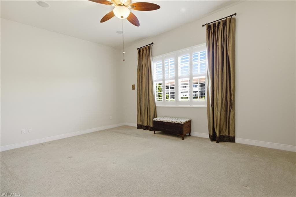 Primary Bedroom with windows overlooking the lake