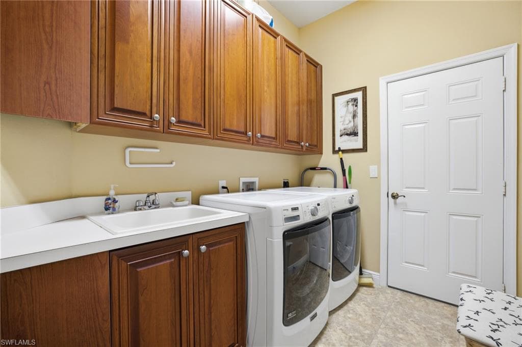 Laundry room with sink cabinets washer and dryer hookups