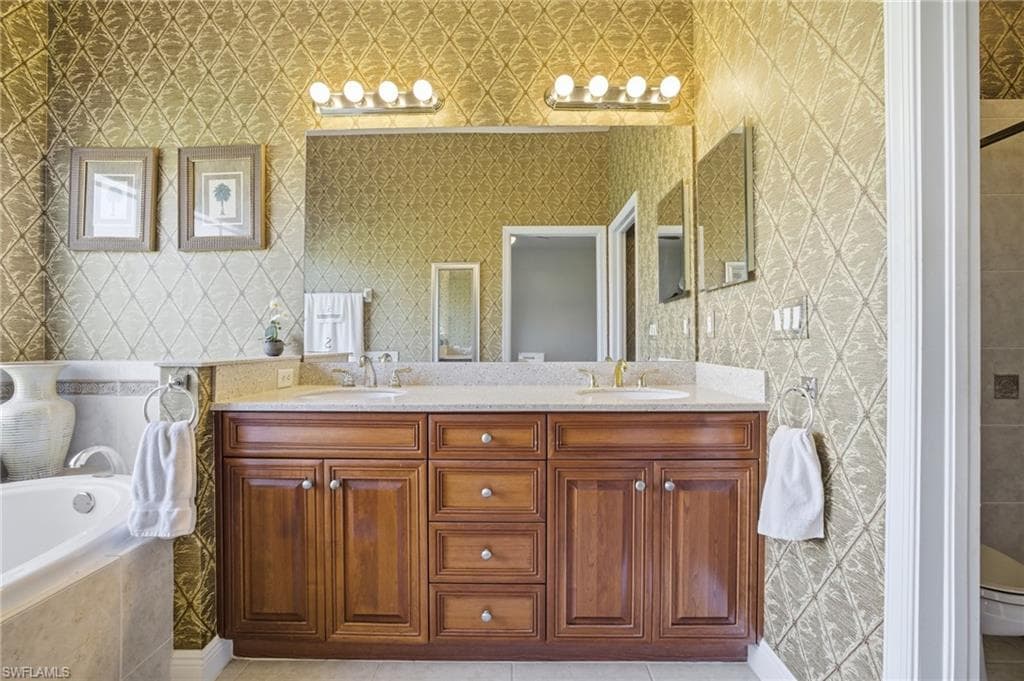 Primary Bathroom with soaking tub, dual sinks, cabinetry