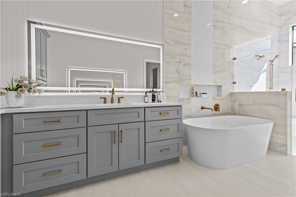 Full bathroom featuring vanity, tile walls, a freestanding bath, and walk in shower