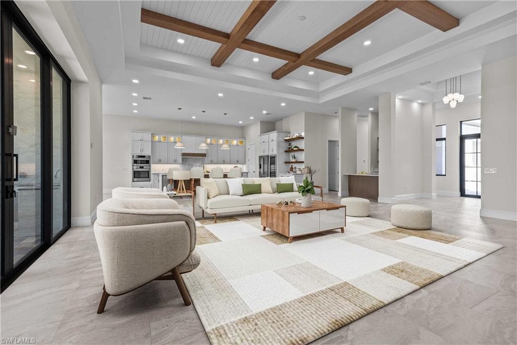 Living room with beam ceiling, coffered ceiling, recessed lighting, and a towering ceiling