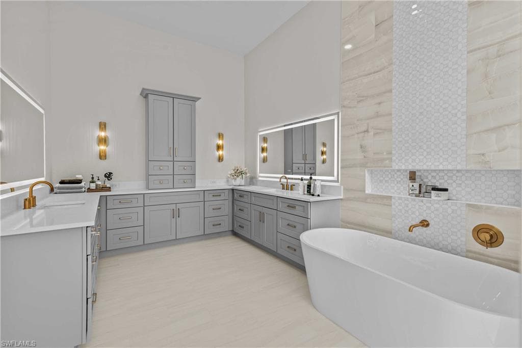Full bath with a freestanding tub and two vanities