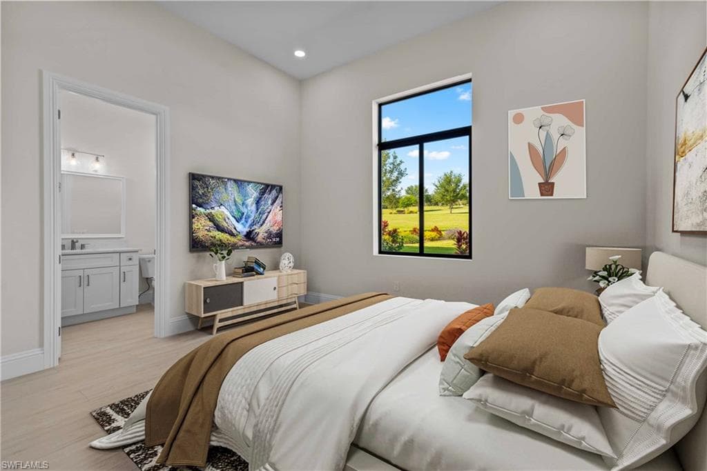 Bedroom with wood finished floors, ensuite bathroom, and recessed lighting