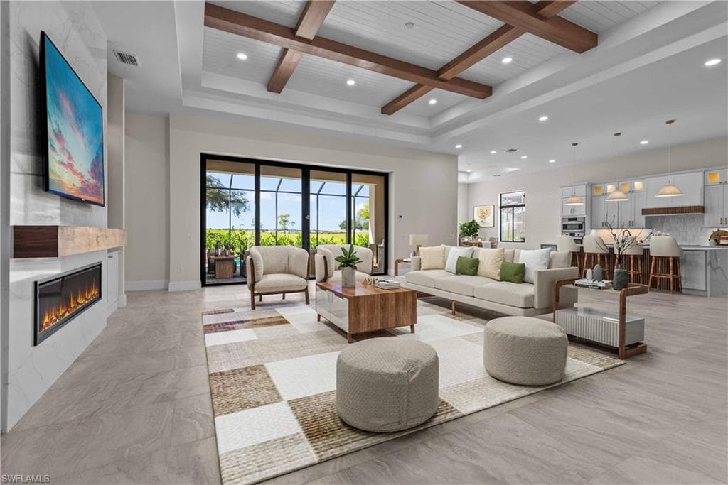 Living area with healthy amount of natural light, coffered ceiling, recessed lighting, a large fireplace, and a wooden ceiling with exposed beams