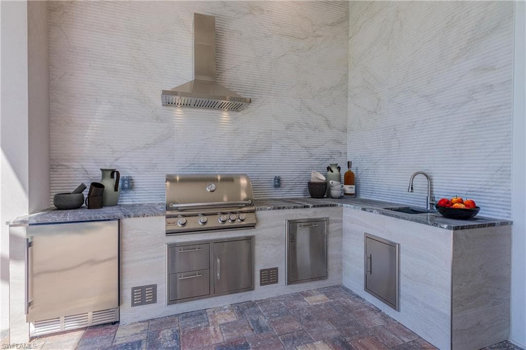 View of patio / terrace with exterior kitchen and a sink