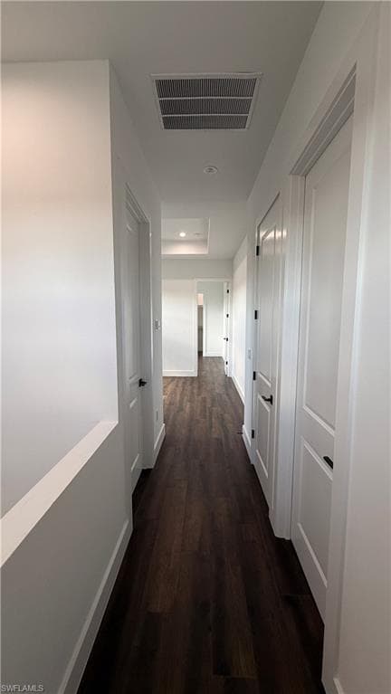 Hallway featuring dark wood-type flooring and recessed lighting