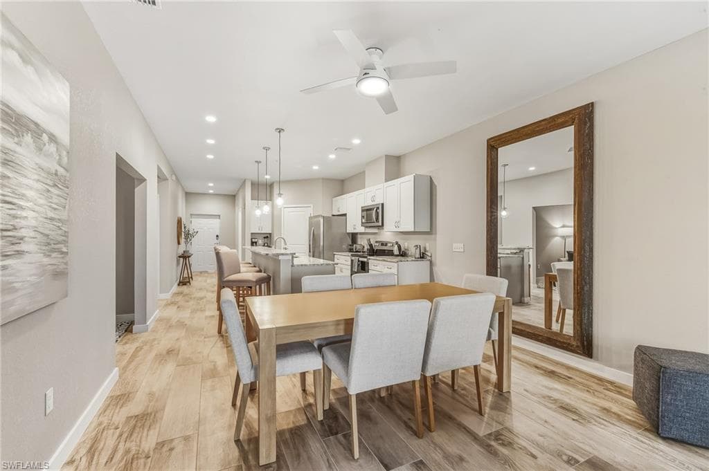 Dining room featuring light wood-style floors, recessed lighting, and ceiling fan