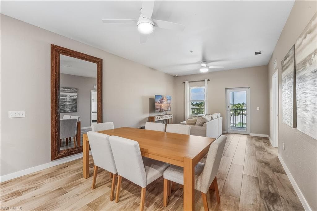 Dining space featuring light wood finished floors and a ceiling fan