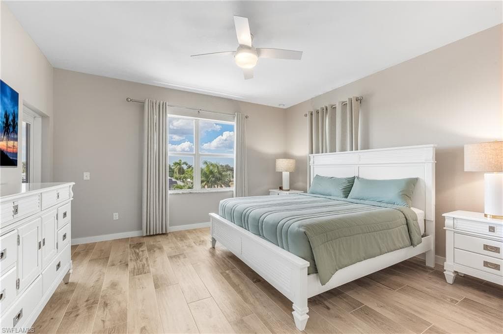 Bedroom featuring light wood-style flooring and a ceiling fan