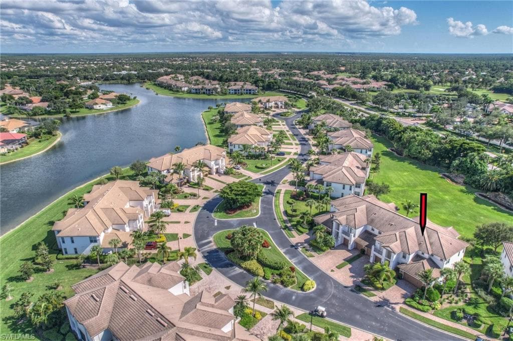 Aerial perspective of suburban area featuring a nearby body of water