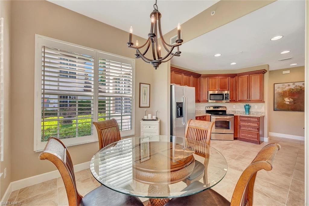 Dining space featuring a chandelier, recessed lighting, and light tile patterned floors