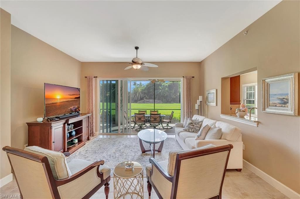 Living area with light tile patterned flooring and ceiling fan