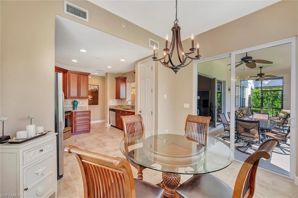 Dining room with recessed lighting, a chandelier, a ceiling fan, and light tile patterned flooring