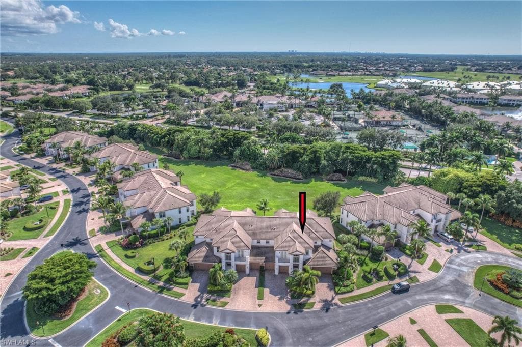 Aerial view of property's location featuring nearby suburban area and a large body of water