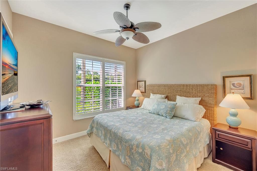 Bedroom featuring light carpet and ceiling fan