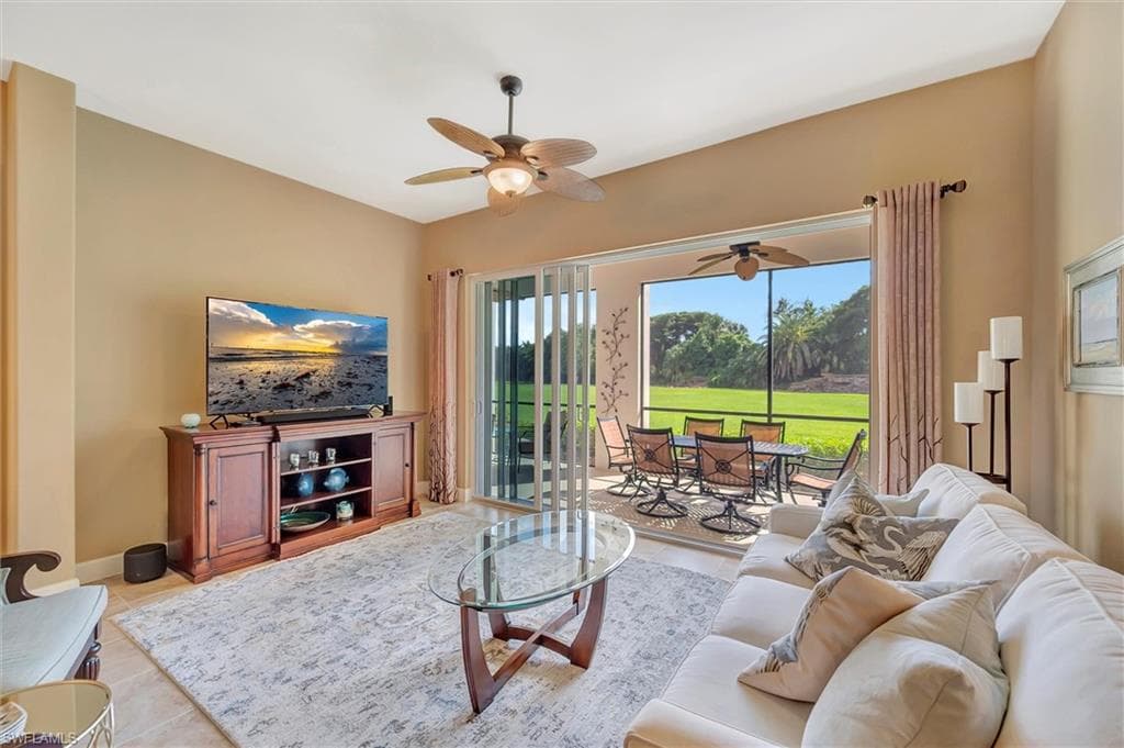 Tiled living room with baseboards and ceiling fan