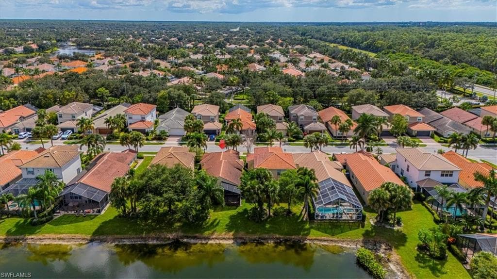 Aerial view of residential area featuring a nearby body of water